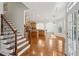 Open-concept living space with hardwood floors, staircase, kitchen, and dining area with great natural light at 5615 Toccoa Dr, Douglasville, GA 30135