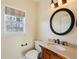 Charming powder room with an ornate vanity, decorative mirror, and classic fixtures at 5615 Toccoa Dr, Douglasville, GA 30135