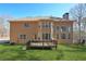 Back exterior view showcasing a deck and well-maintained lawn at 5615 Toccoa Dr, Douglasville, GA 30135
