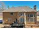 Back exterior of the home featuring a deck and expansive windows at 5615 Toccoa Dr, Douglasville, GA 30135