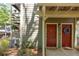 Charming condo entrance with well-maintained landscaping and red front doors at 606 Se Riverview Dr # 606, Marietta, GA 30067