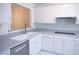 Modern kitchen with white cabinets, stainless steel appliances, and grey countertops at 606 Se Riverview Dr # 606, Marietta, GA 30067