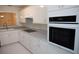 Modern kitchen features white cabinets, stainless steel appliances, and updated countertops at 606 Se Riverview Dr # 606, Marietta, GA 30067