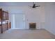 Loft view of living room with fireplace, fan, built-ins, and natural light at 606 Se Riverview Dr # 606, Marietta, GA 30067
