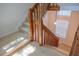 Carpeted staircase featuring wood railing and a light-filled landing at 606 Se Riverview Dr # 606, Marietta, GA 30067