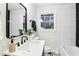 Modern bathroom with black and white tiling, modern vanity, and updated fixtures at 814 Bank St, Smyrna, GA 30080