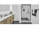 Bathroom featuring dual sinks with modern fixtures and a glass enclosed shower at 814 Bank St, Smyrna, GA 30080
