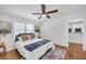 Bright bedroom featuring hardwood floors, a ceiling fan, and closet for ample storage at 814 Bank St, Smyrna, GA 30080