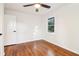 This bedroom features hardwood floors, a ceiling fan, and a bright window at 814 Bank St, Smyrna, GA 30080
