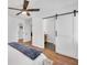White bedroom featuring hardwood floors and a closet with a modern sliding door at 814 Bank St, Smyrna, GA 30080