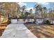 Charming single-story home featuring a well-manicured lawn, a long driveway, and a classic exterior design at 814 Bank St, Smyrna, GA 30080