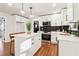 Well-lit kitchen with white cabinetry, stainless steel appliances, an island, and modern finishes at 814 Bank St, Smyrna, GA 30080