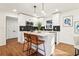 Bright kitchen featuring white cabinets, stainless steel appliances, a center island, and hardwood floors at 814 Bank St, Smyrna, GA 30080
