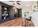 Open-concept living room with a desk, built-in shelves, and a brick fireplace at 814 Bank St, Smyrna, GA 30080
