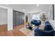 Cozy living room featuring hardwood floors, a statement wall, and ample natural light from a large window at 814 Bank St, Smyrna, GA 30080