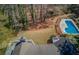 Aerial view of the property highlighting the pool, spacious yard, and surrounding trees at 1564 Beaver Creek Lane, Snellville, GA 30078