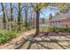 Beautiful backyard with mature trees, landscaping, and a charming stone-lined path at 1564 Beaver Creek Lane, Snellville, GA 30078