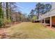 Large backyard features mature landscaping, leading to a private in-ground pool and home's walkout basement at 1564 Beaver Creek Lane, Snellville, GA 30078