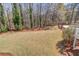 Large, well-maintained backyard with mature trees and a pool, offering privacy and recreation at 1564 Beaver Creek Lane, Snellville, GA 30078