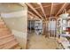 Unfinished basement with exposed ceiling, utilities, and wood stairs ready for customization at 1564 Beaver Creek Lane, Snellville, GA 30078
