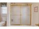 This bathroom features a shower with gold trim and glass doors at 1564 Beaver Creek Lane, Snellville, GA 30078