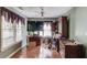 This bedroom area features a window, ceiling fan, desk, drawers, and wood flooring at 1564 Beaver Creek Lane, Snellville, GA 30078