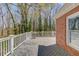 Spacious wooden deck features white railings, offering an outdoor retreat with views of the surrounding trees at 1564 Beaver Creek Lane, Snellville, GA 30078