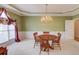 Bright dining room featuring a chandelier, trim detail, and a large window for ample natural light at 1564 Beaver Creek Lane, Snellville, GA 30078