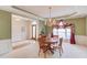 Bright dining room featuring a chandelier, trim detail, and a large window for ample natural light at 1564 Beaver Creek Lane, Snellville, GA 30078