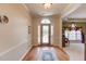 Elegant foyer featuring hardwood floors, decorative trim, and a view into the adjacent dining room and living area at 1564 Beaver Creek Lane, Snellville, GA 30078