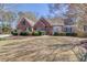 Charming brick home featuring a well-manicured lawn and mature landscaping that enhances its curb appeal at 1564 Beaver Creek Lane, Snellville, GA 30078