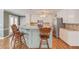Kitchen features breakfast bar with seating, ample counter space, stainless steel appliances, and bright, white cabinets at 1564 Beaver Creek Lane, Snellville, GA 30078
