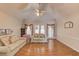 Spacious living room with hardwood flooring, a ceiling fan, and French doors that lead to the outside at 1564 Beaver Creek Lane, Snellville, GA 30078