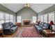 Bright living room boasts vaulted ceiling, fireplace, hardwood floors, and plentiful natural light from large windows at 1564 Beaver Creek Lane, Snellville, GA 30078