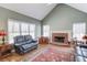 Comfortable living room featuring a fireplace, a large window, and hardwood floors with an area rug at 1564 Beaver Creek Lane, Snellville, GA 30078