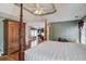 A spacious main bedroom features a wooden four poster bed and a wooden cabinet at 1564 Beaver Creek Lane, Snellville, GA 30078