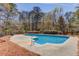 Inground swimming pool in a fenced backyard, surrounded by nature, with slide and diving board at 1564 Beaver Creek Lane, Snellville, GA 30078