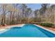 Large in-ground swimming pool nestled in a private backyard, offering a refreshing outdoor escape at 1564 Beaver Creek Lane, Snellville, GA 30078