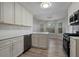 Bright kitchen with white cabinetry, stainless steel appliances, and stylish lighting at 4625 Thermal Ct, Douglasville, GA 30135