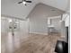 Open living room featuring wood floors, high ceilings, and a fireplace at 4625 Thermal Ct, Douglasville, GA 30135