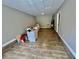 Spacious basement area features wood-style ceramic tile and neutral-toned walls at 6123 Deerfield Ct, Morrow, GA 30260