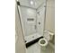 Bathroom features a glass-enclosed shower with marble-look tile and modern fixtures at 6123 Deerfield Ct, Morrow, GA 30260