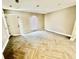 Comfortable bedroom with natural light, herringbone tiled flooring and neutral paint throughout at 6123 Deerfield Ct, Morrow, GA 30260