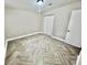 Bright bedroom with neutral paint, herringbone tiled flooring and a spacious closet at 6123 Deerfield Ct, Morrow, GA 30260