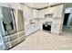 Bright kitchen with stainless steel appliances, white cabinets, and a modern backsplash with tiled floor at 6123 Deerfield Ct, Morrow, GA 30260