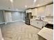 Open-concept kitchen and living area with stainless steel appliances, white cabinets and ample counter space at 6123 Deerfield Ct, Morrow, GA 30260