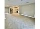 Open concept living room and kitchen area with herringbone tiled flooring and recessed lighting throughout at 6123 Deerfield Ct, Morrow, GA 30260