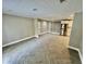 Spacious living room with herringbone tiled flooring, recessed lighting and neutral paint throughout at 6123 Deerfield Ct, Morrow, GA 30260