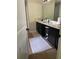 Bathroom featuring modern vanity with dark cabinetry, white rug, and tile floors at 6802 Potomac, Fairburn, GA 30213