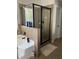 Clean bathroom featuring glass enclosed shower, tiled walls, and soaking tub at 6802 Potomac, Fairburn, GA 30213